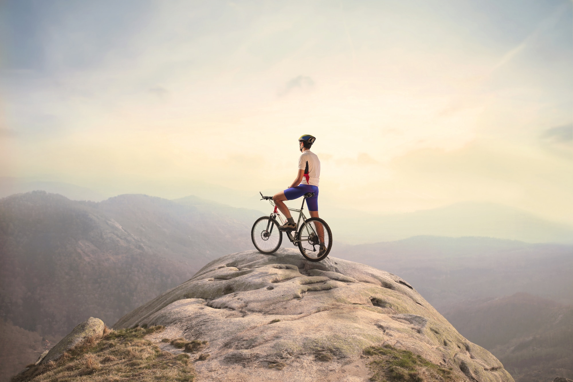 Rider overlooking mountain vista while riding a mountain bike