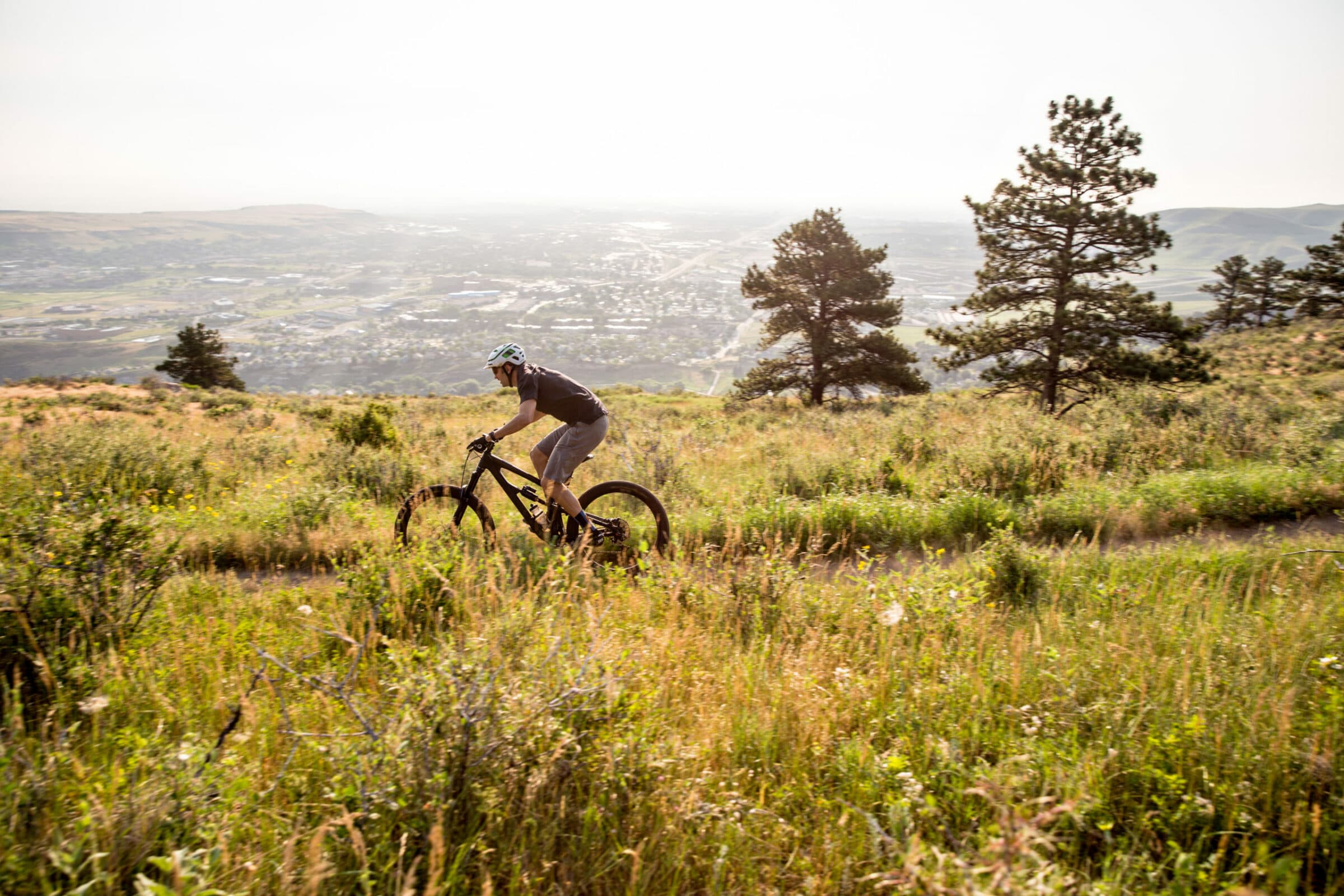 mountain bike shop man riding mountain bike through colorado trail