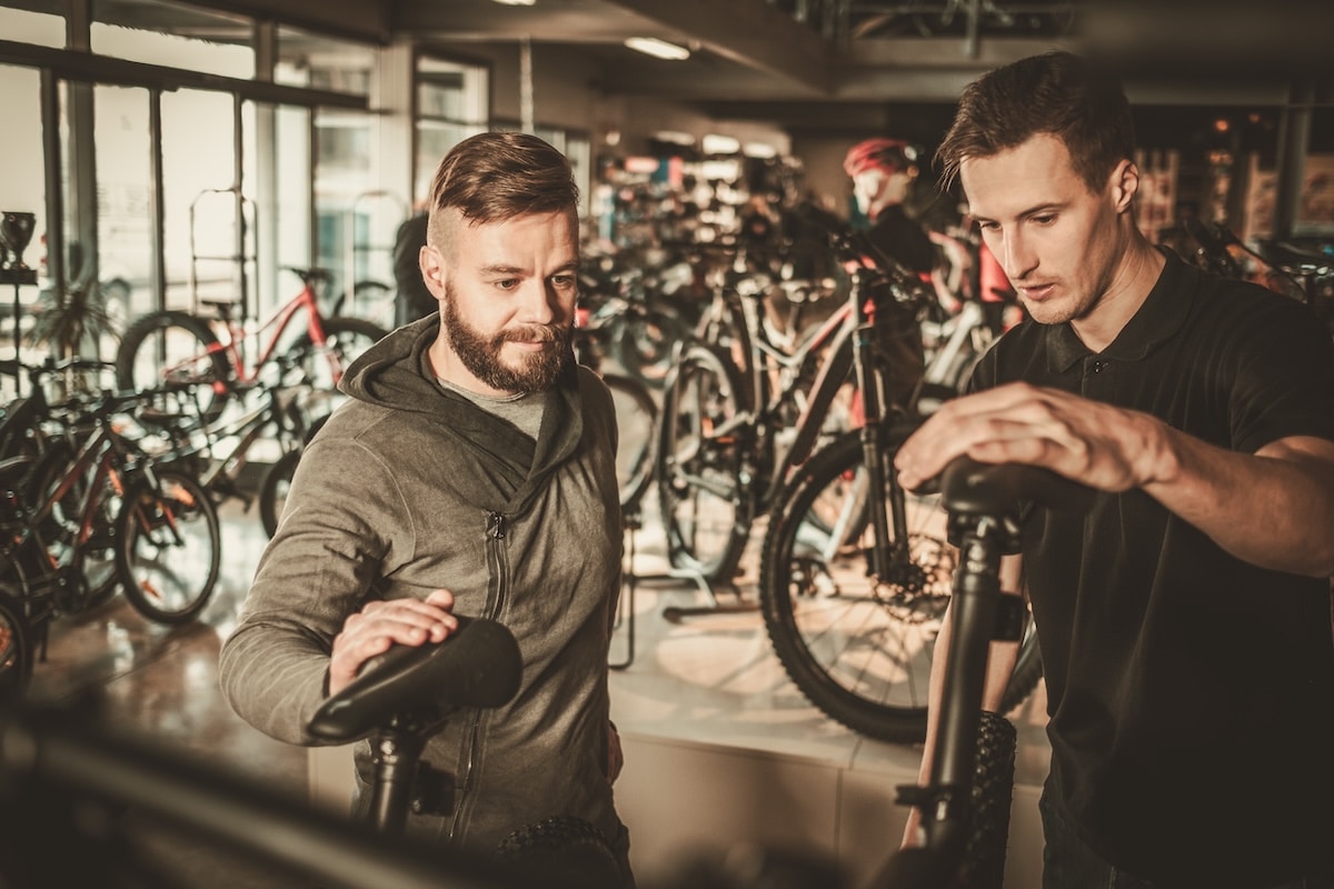 two men discussing a mountain bike rental